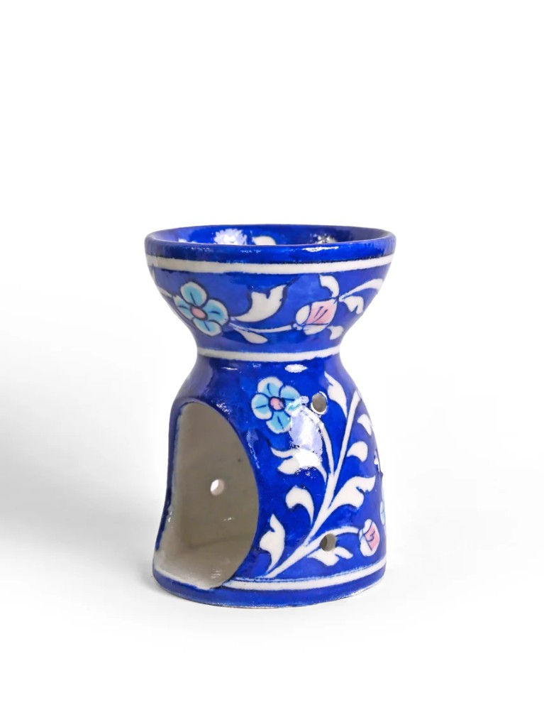 Blue pottery oil burner angle view